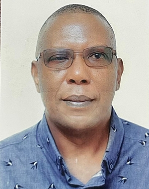 The photo shows John Mark Mwanika as Program Manager at FES TUCC
